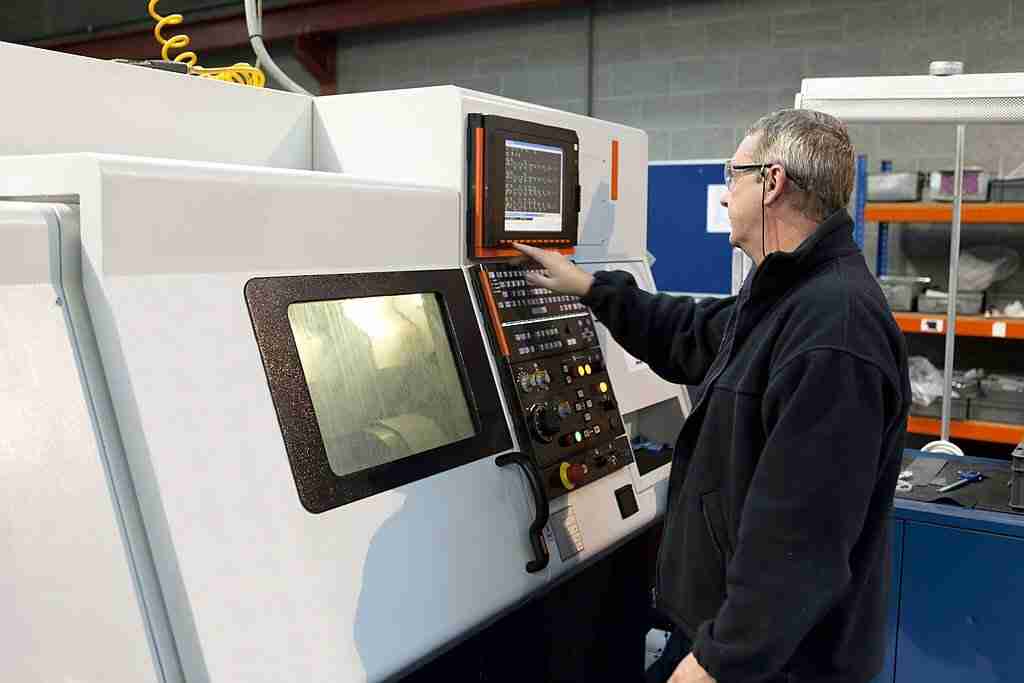 Man operating closed lathe