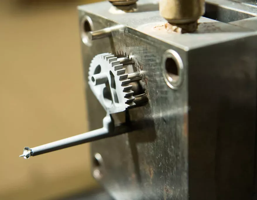 Close up of a gear being molded during the metal injection molding process