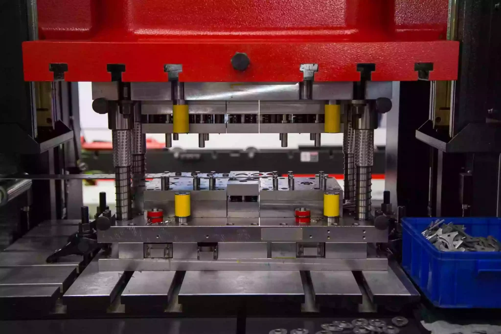 Continuous sheet metal stamping batch manufacturing of precision parts